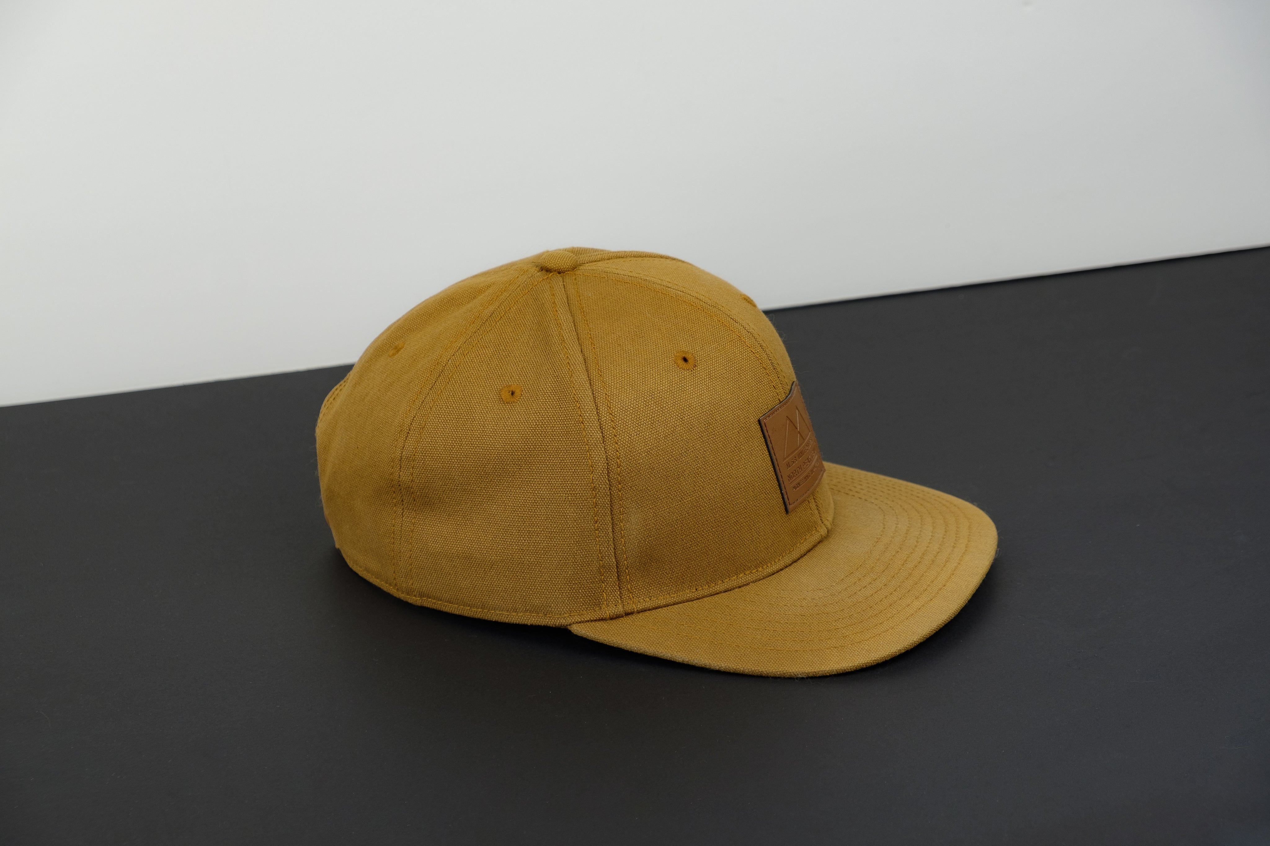 tan-colored-hat-on-monochrome-background.jpg